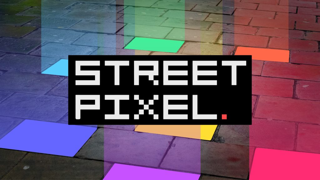 A section of pavement with 7 paving slabs lit up and shining coloured lights upward. The Street Pixel logo is in front of the lights. 